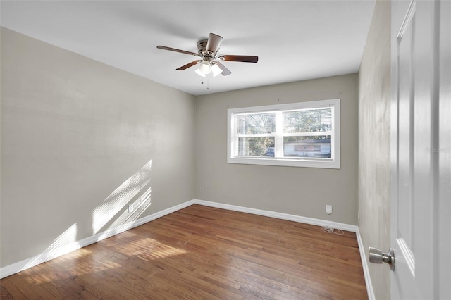 spare room with ceiling fan and wood-type flooring