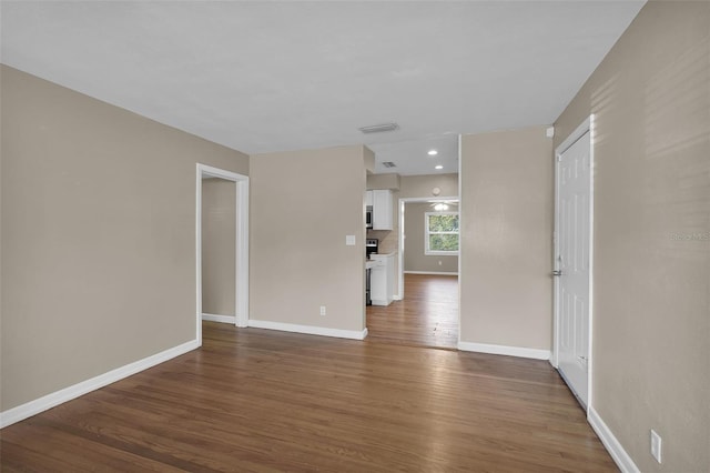 unfurnished room featuring dark hardwood / wood-style flooring