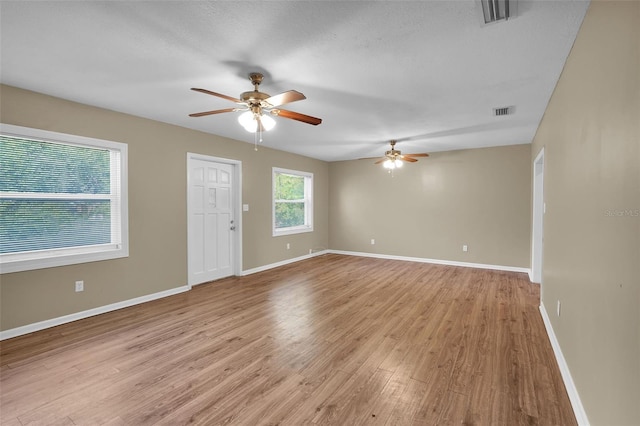 empty room with light hardwood / wood-style floors and ceiling fan