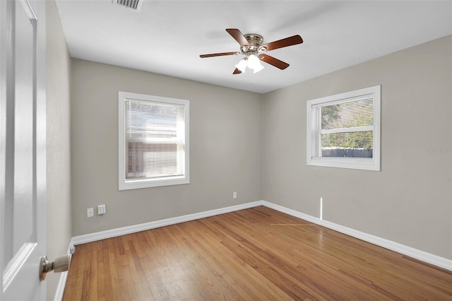 unfurnished room with hardwood / wood-style flooring and ceiling fan