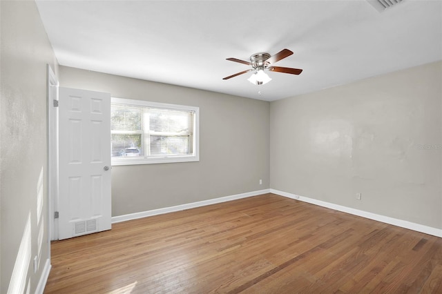 empty room with ceiling fan and light hardwood / wood-style flooring