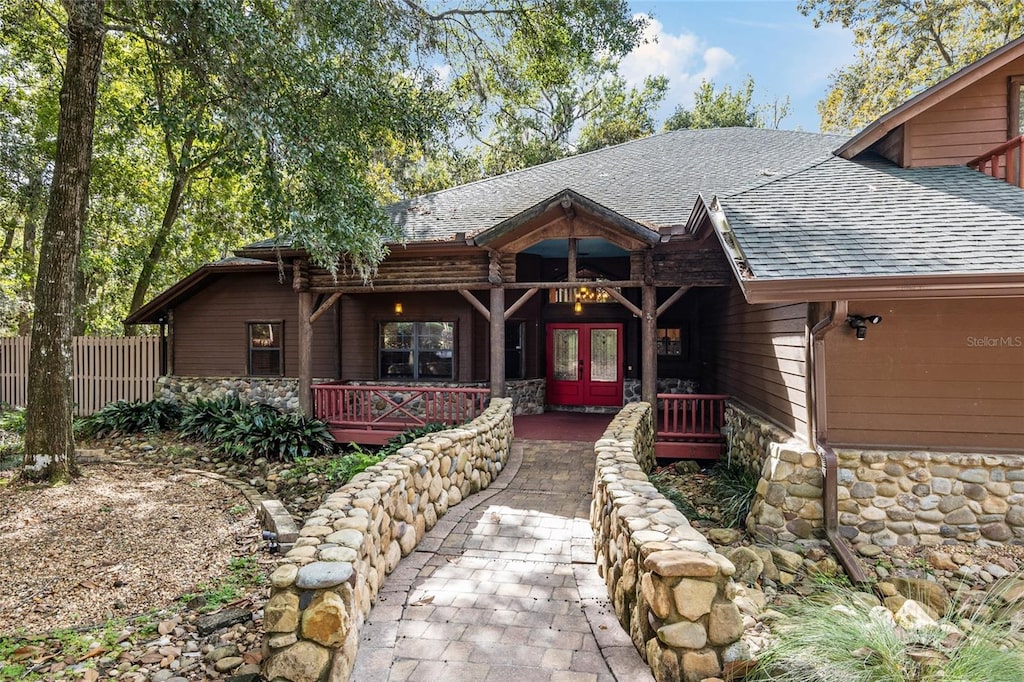 view of front of home featuring french doors and covered porch