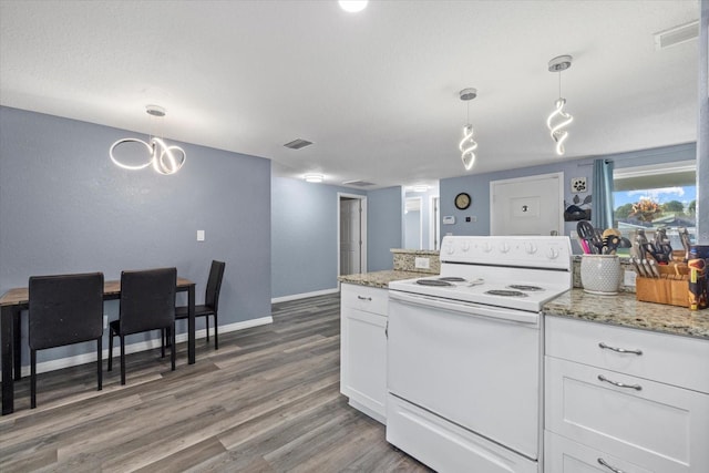 kitchen with light stone countertops, white electric range oven, dark wood-type flooring, white cabinets, and hanging light fixtures