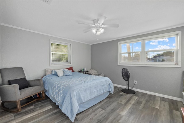 bedroom with ornamental molding, ceiling fan, and wood-type flooring