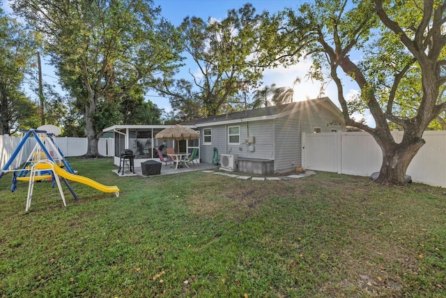 back of house featuring a playground, a patio area, and a yard