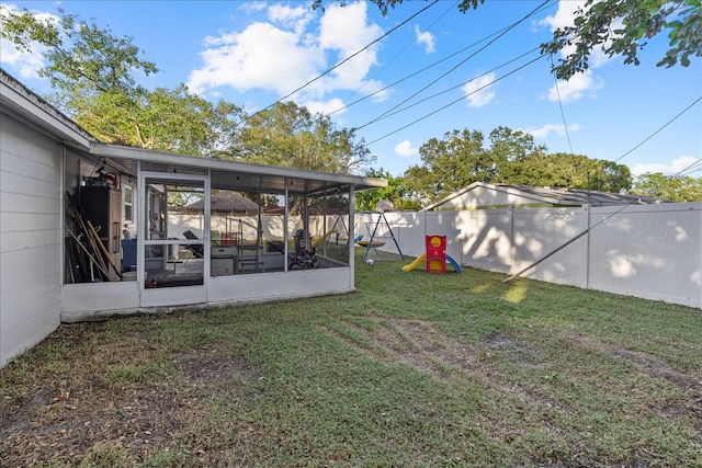 view of yard with a playground and a sunroom