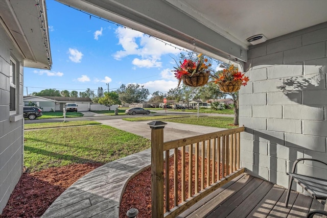 deck with covered porch and a yard