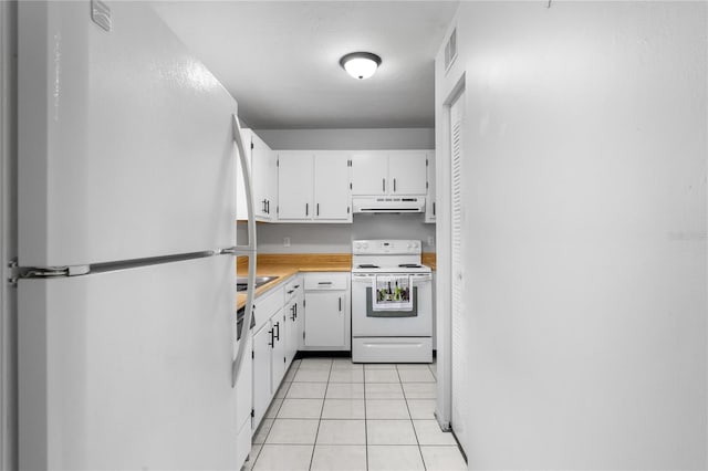 kitchen with white appliances, light countertops, under cabinet range hood, white cabinetry, and light tile patterned flooring