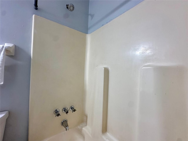 full bathroom with shower / bath combination and toilet