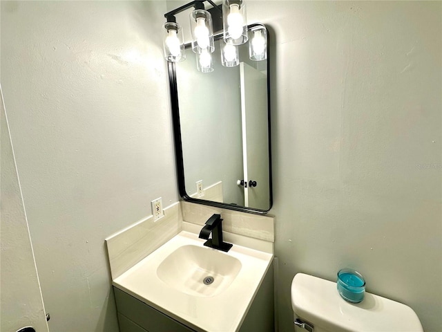 bathroom featuring toilet and vanity