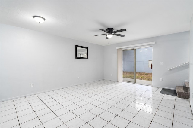 unfurnished room featuring a ceiling fan, light tile patterned flooring, baseboards, and stairs