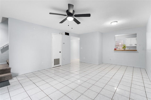 spare room featuring ceiling fan, stairs, and visible vents