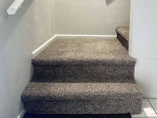 stairs with a textured wall