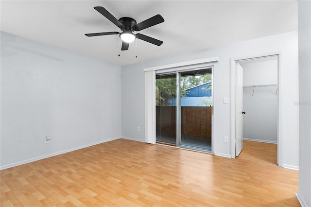 empty room featuring light wood-type flooring, ceiling fan, and baseboards