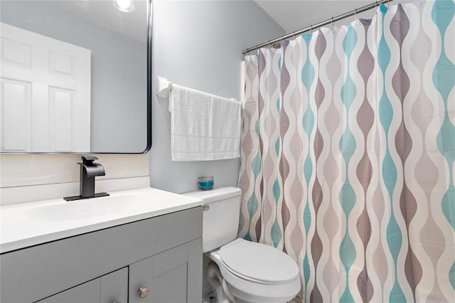 bathroom featuring toilet and vanity