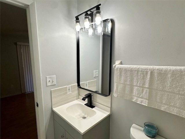 bathroom featuring toilet and vanity