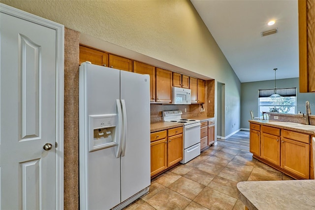 kitchen with sink, vaulted ceiling, decorative light fixtures, white appliances, and light tile patterned floors