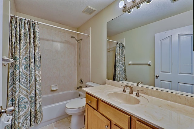 full bathroom featuring shower / bath combo, vanity, a textured ceiling, tile patterned flooring, and toilet