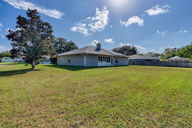 back of house with a yard