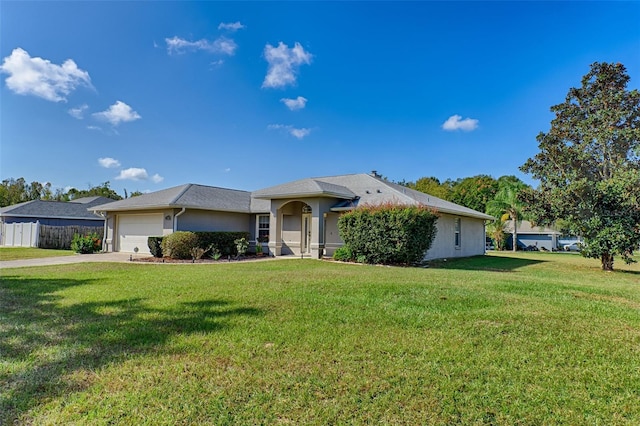 single story home featuring a garage and a front lawn