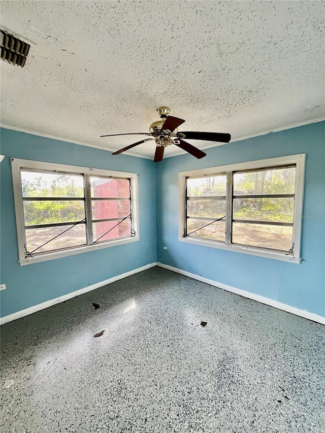 spare room with ceiling fan and a textured ceiling