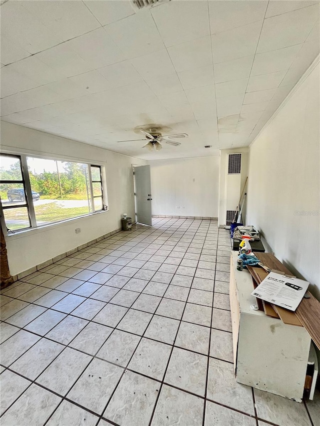 interior space featuring light tile patterned floors and ceiling fan