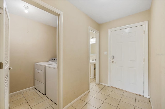 laundry room with light tile patterned floors and independent washer and dryer