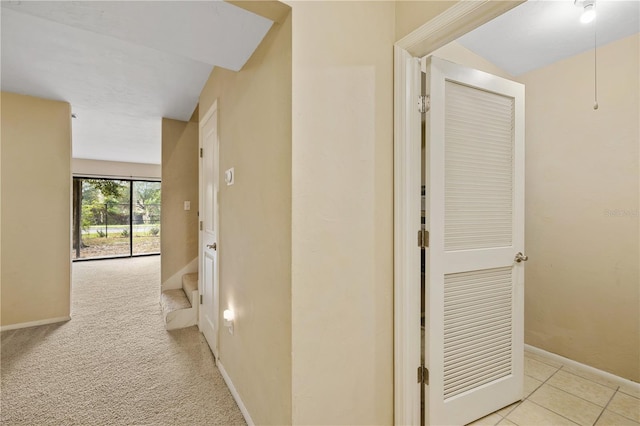 hall with light colored carpet