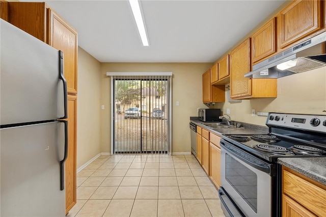 kitchen with sink, light tile patterned floors, exhaust hood, and appliances with stainless steel finishes