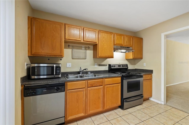 kitchen with light tile patterned floors, stainless steel appliances, and sink