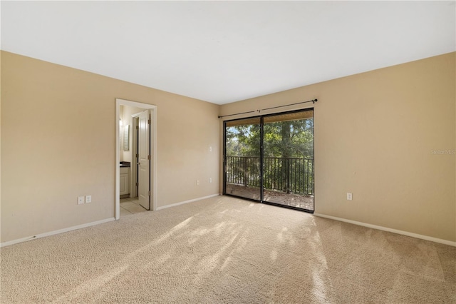 unfurnished room featuring light carpet