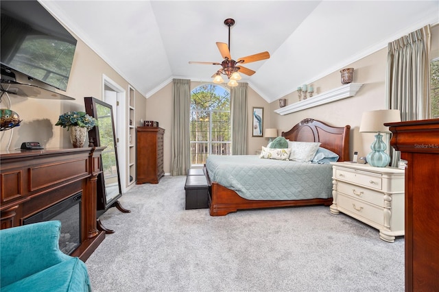 carpeted bedroom with ceiling fan, lofted ceiling, and ornamental molding