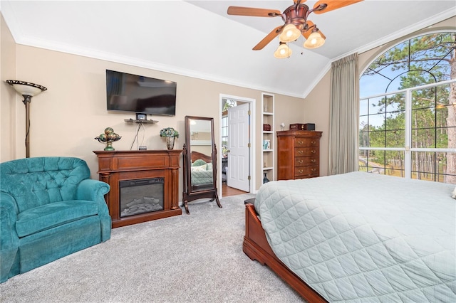 carpeted bedroom featuring vaulted ceiling, ceiling fan, and ornamental molding