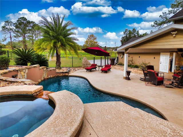 view of pool featuring an in ground hot tub and a patio