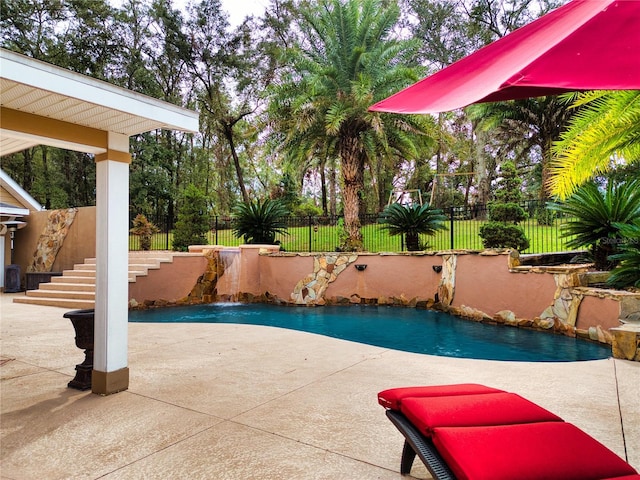 view of swimming pool featuring pool water feature and a patio