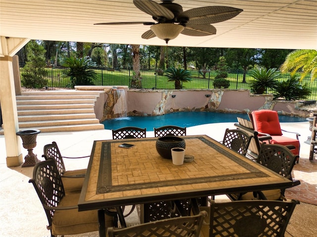 view of patio featuring pool water feature, ceiling fan, and a fenced in pool