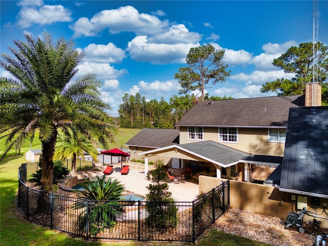 back of house featuring a patio area and an outdoor hangout area