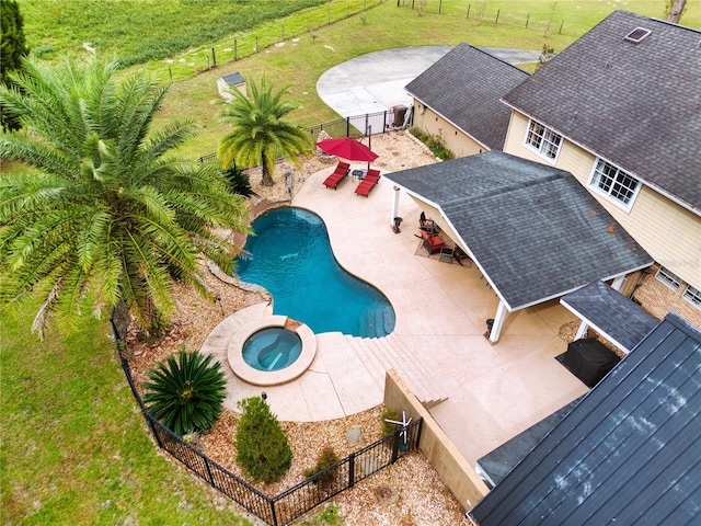 view of pool with a patio area and an in ground hot tub