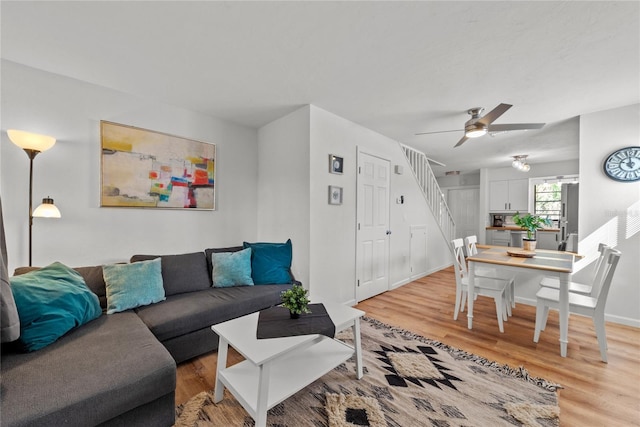 13433 Heald Ln Unit 1A, Fort Myers, FL 33908 - living area with light wood-type flooring, a ceiling fan, stairway, and baseboards