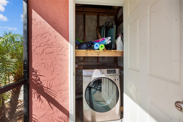 clothes washing area with washer / dryer