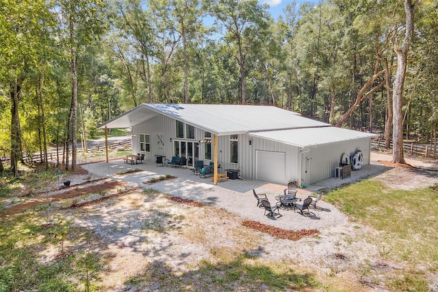 back of property with a patio area and a garage