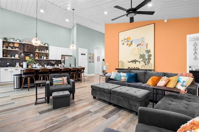 living room with ceiling fan, light hardwood / wood-style flooring, high vaulted ceiling, and wooden ceiling