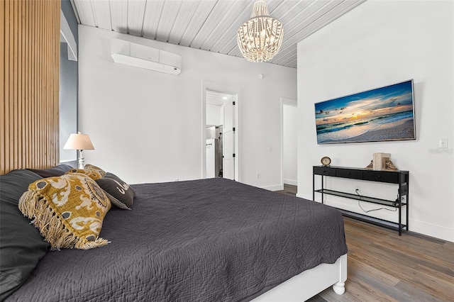 bedroom featuring a wall unit AC, dark hardwood / wood-style flooring, wood ceiling, and a notable chandelier