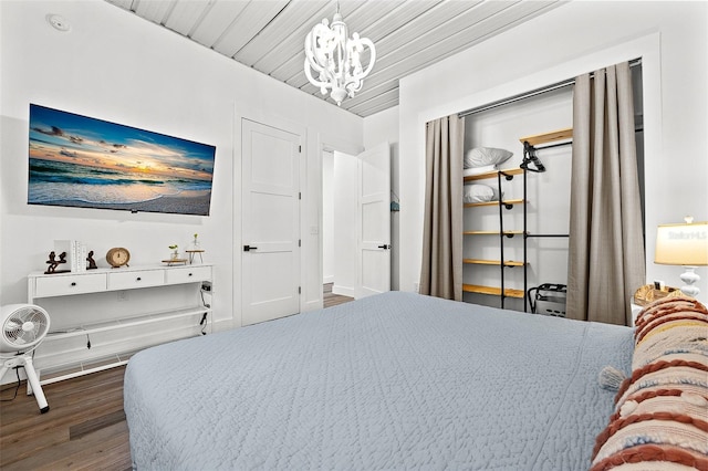 bedroom featuring dark hardwood / wood-style flooring, wood ceiling, and a notable chandelier