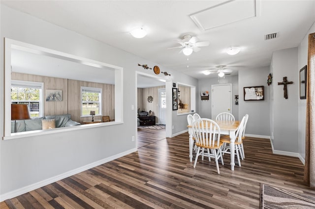 dining room with ceiling fan and dark hardwood / wood-style flooring