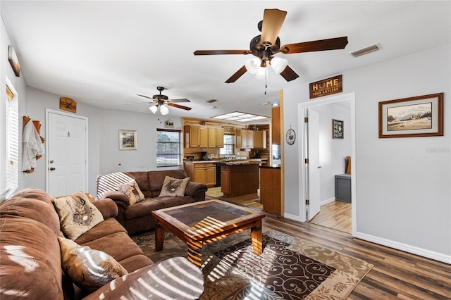 living room featuring ceiling fan and wood-type flooring