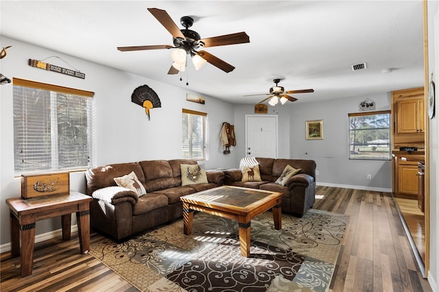 living room with ceiling fan and dark hardwood / wood-style flooring