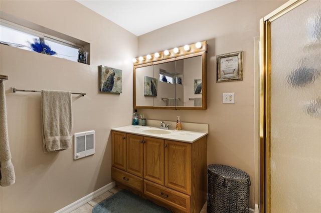 bathroom featuring tile patterned flooring, vanity, heating unit, and walk in shower