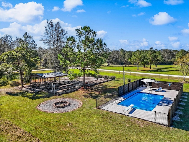 view of pool featuring a yard, an outdoor fire pit, a diving board, a gazebo, and a patio area