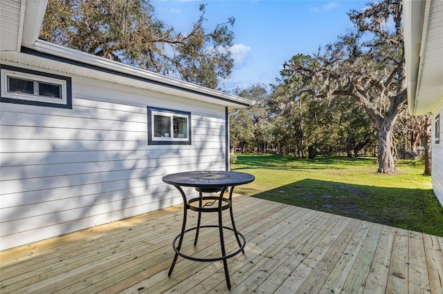 wooden deck featuring a yard